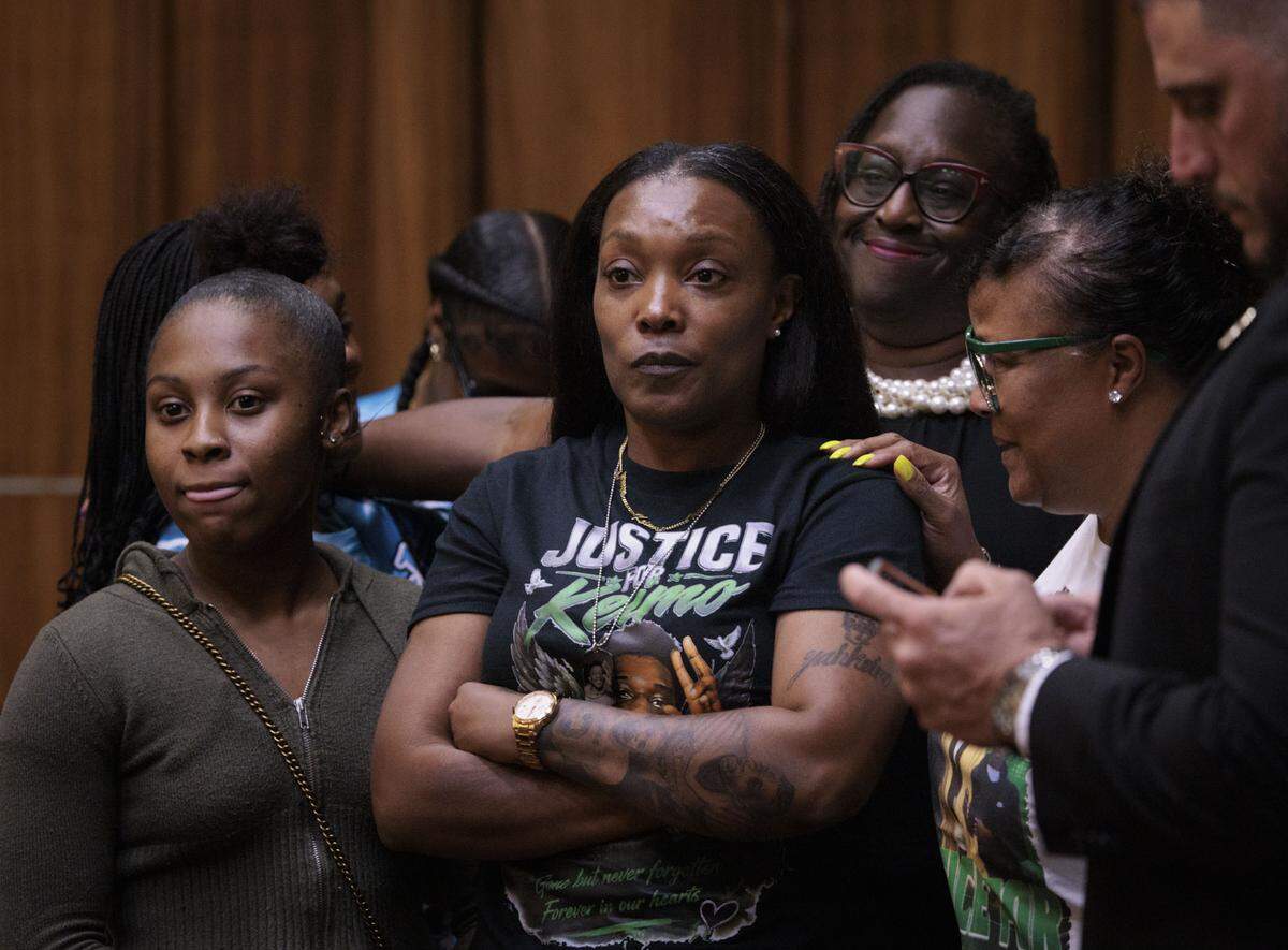 Nathalie Jean, the mother of Yahkeim Lollar, center, is surrounded by family after Jahara Malik was sentenced on Tuesday, May 5, 2026, to 17 years in prison for the death of her son. 